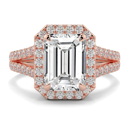 Rose gold ring with emerald-cut diamond and smaller diamonds on a white background Yb jewellers emerald split halo diamond engagement ring 