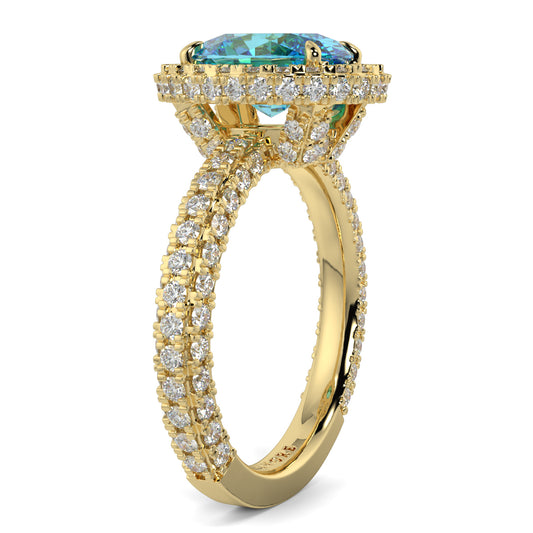 Gold ring with a blue gemstone and diamond accents on a white background oval diamond halo lab grown blue diamond engagement ring - 18k yellow gold diamond ring