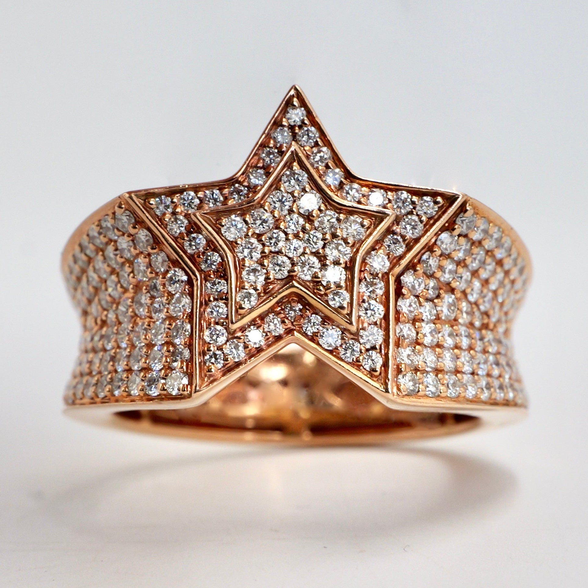 Rose gold star-shaped ring with diamond accents on a light gray background hip hop pinky ring rose gold diamond set yb jewellers best selling rings