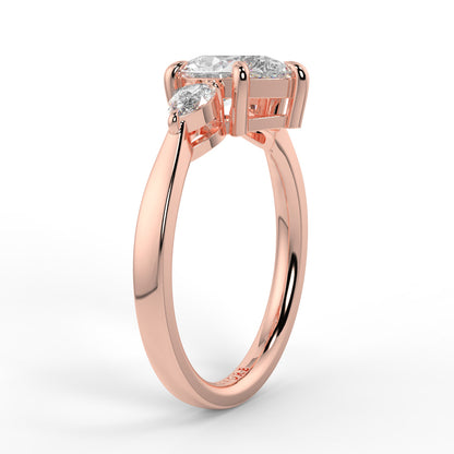 Rose gold ring with two diamonds on a white background _yb_jewellers_3_stone_trilogy_engagement_ring_round_and_pear_shape_best_selling_design_trending_diamond_ring