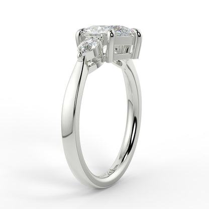 Diamond ring with a white gold band on a light gray background _yb_jewellers_3_stone_trilogy_engagement_ring_round_and_pear_shape_best_selling_design_trending_diamond_ring