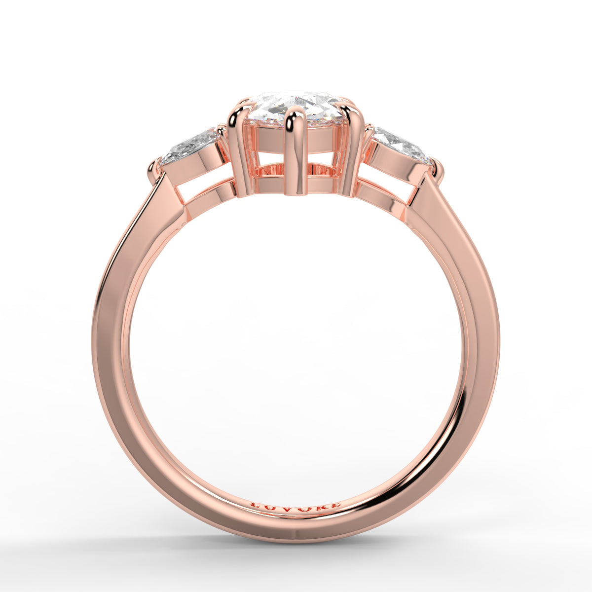 Rose gold ring with three diamonds on a white background _yb_jewellers_3_stone_trilogy_engagement_ring_round_and_pear_shape_best_selling_design_trending_diamond_ring