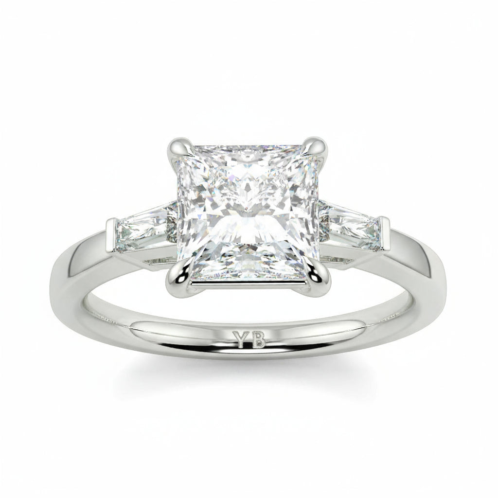 Diamond ring with a princess-cut center stone on a white background yb_jewellers_3_stone_trilogy_engagement_ring_round_and_pear_shape_best_selling_design_trending_diamond_ring