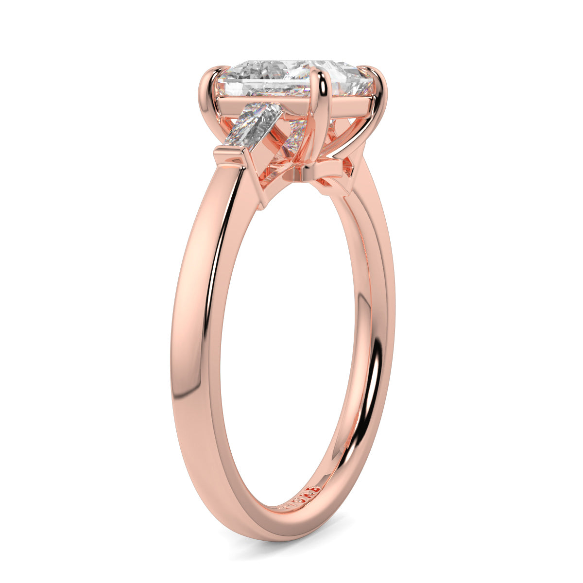 Rose gold ring with a diamond on a white background yb_jewellers_3_stone_trilogy_engagement_ring_round_and_pear_shape_best_selling_design_trending_diamond_ring