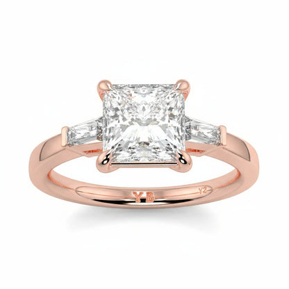 Rose gold ring with a diamond on a white background yb_jewellers_3_stone_trilogy_engagement_ring_round_and_pear_shape_best_selling_design_trending_diamond_ring