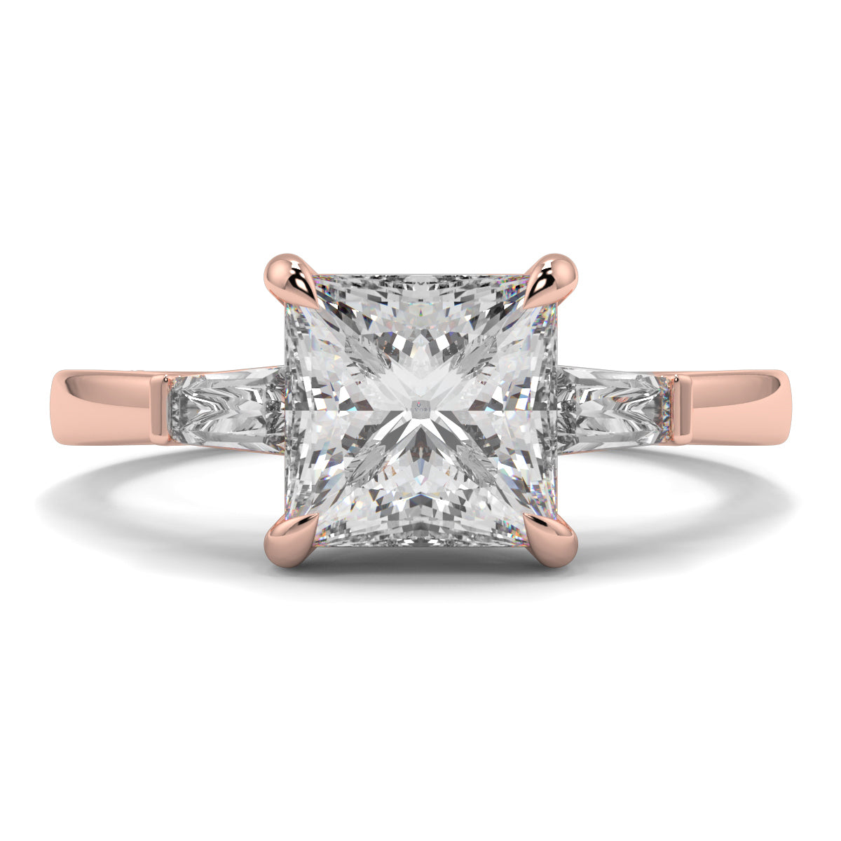 Rose gold ring with a large diamond on a white background yb_jewellers_3_stone_trilogy_engagement_ring_round_and_pear_shape_best_selling_design_trending_diamond_ring