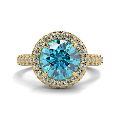 Gold ring with a blue gemstone and diamond accents on a white background yb jewellers round yellow gold halo engagement ring diamond ring