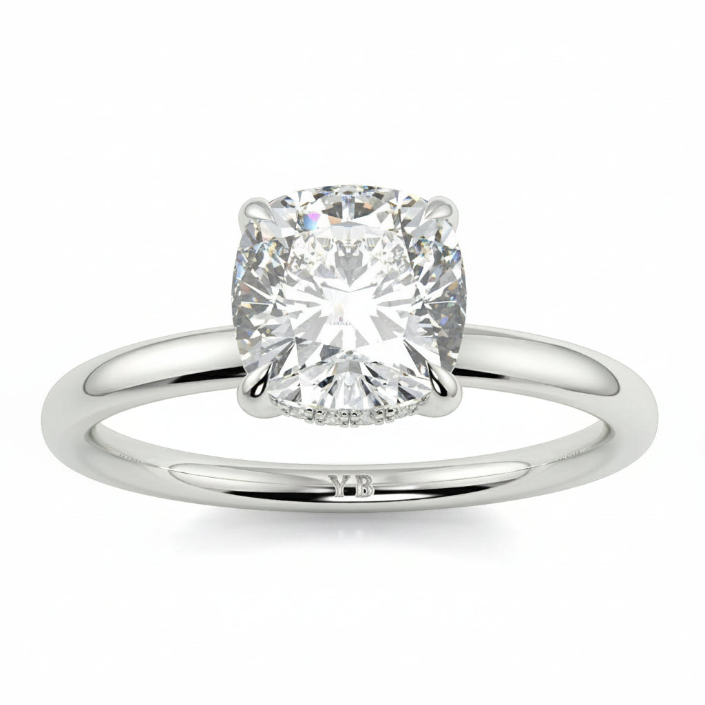 Diamond ring with branding on a white background yb jewellers solitaire engagement ring best selling design cushion shape diamond 4 claw with a slim band