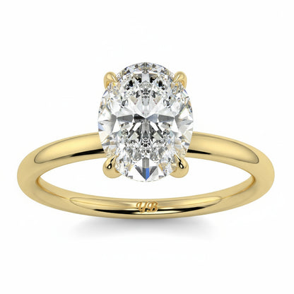 Gold ring with a large diamond on a white background yb_jewellers_solitaire_engagement_ring_best_selling_design_cushion_shape_diamond_4_claw_with_a_slim_band