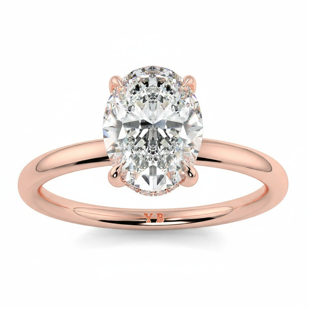 Rose gold ring with a large diamond on a white background yb_jewellers_solitaire_engagement_ring_best_selling_design_cushion_shape_diamond_4_claw_with_a_slim_band