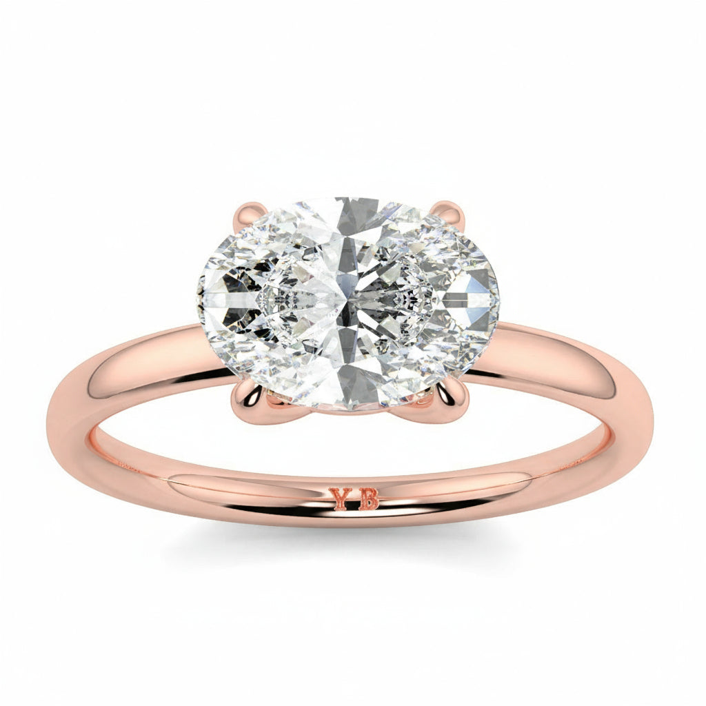 Rose gold ring with a large diamond on a white background yb_jewellers_4_claw_emerald_diamond_engagement_ring_best_selling_design_with_a_thin_band