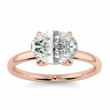 Rose gold ring with a large diamond on a white background yb_jewellers_4_claw_emerald_diamond_engagement_ring_best_selling_design_with_a_thin_band