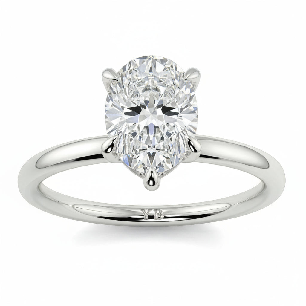 Diamond ring with pear-shaped gemstone on a white background _yb_jewellers_solitaire_engagement_ring_best_selling_design_cushion_shape_diamond_4_claw_with_a_slim_band