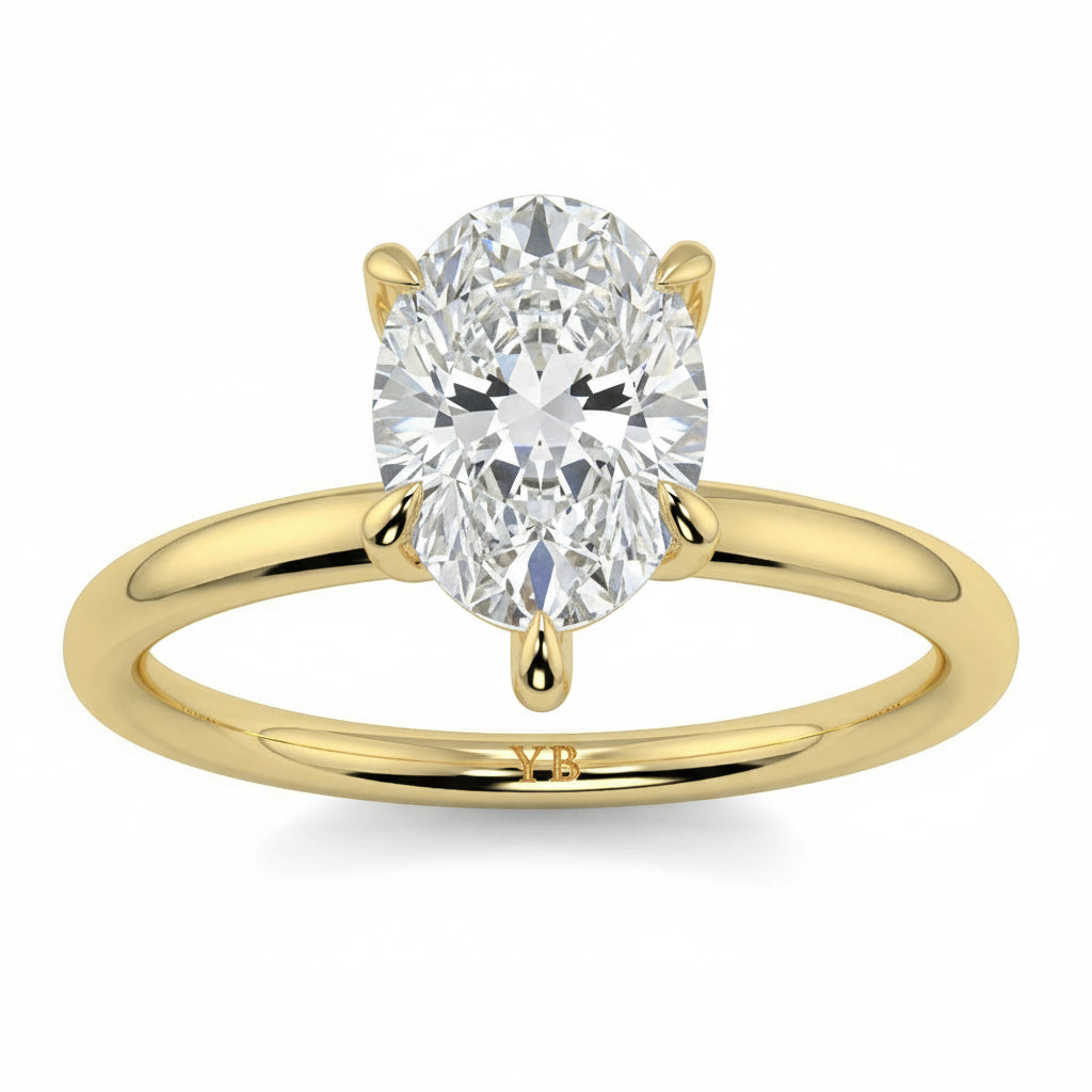 Gold ring with a pear-shaped diamond on a white background _yb_jewellers_solitaire_engagement_ring_best_selling_design_cushion_shape_diamond_4_claw_with_a_slim_band