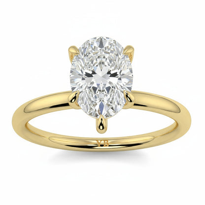 Gold ring with a pear-shaped diamond on a white background _yb_jewellers_solitaire_engagement_ring_best_selling_design_cushion_shape_diamond_4_claw_with_a_slim_band