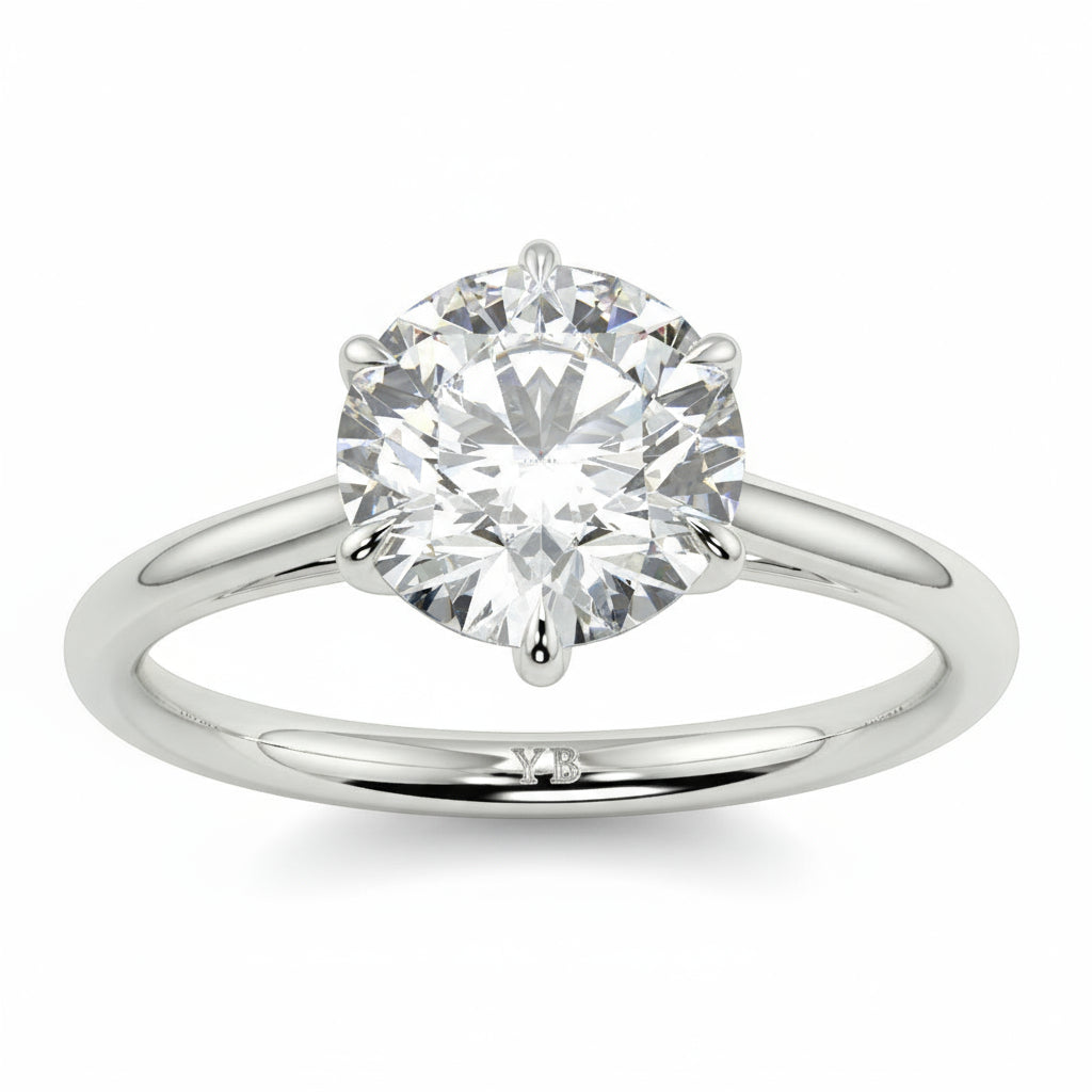 Diamond ring with branding on a white background yb jewellers solitaire engagement ring with 6 claws set similar to tiffany style classic engagement ring round solitaire diamond ring yb jewellers trending jeweller and ring designs 