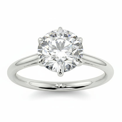 Diamond ring with branding on a white background yb jewellers solitaire engagement ring with 6 claws set similar to tiffany style classic engagement ring round solitaire diamond ring yb jewellers trending jeweller and ring designs 