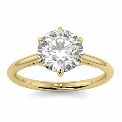Gold ring with a large diamond and  branding on a white background yb jewellers solitaire engagement ring with 6 claws set similar to tiffany style classic engagement ring round solitare diamond ring yb jewellers trending jeweller and ring designs