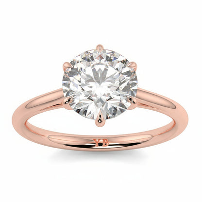 Rose gold ring with a large diamond and  branding on a white background yb jewellers solitaire engagement ring with 6 claws set similar to tiffany style classic engagement ring round solitaire diamond ring yb jewellers trending jeweller and ring designs