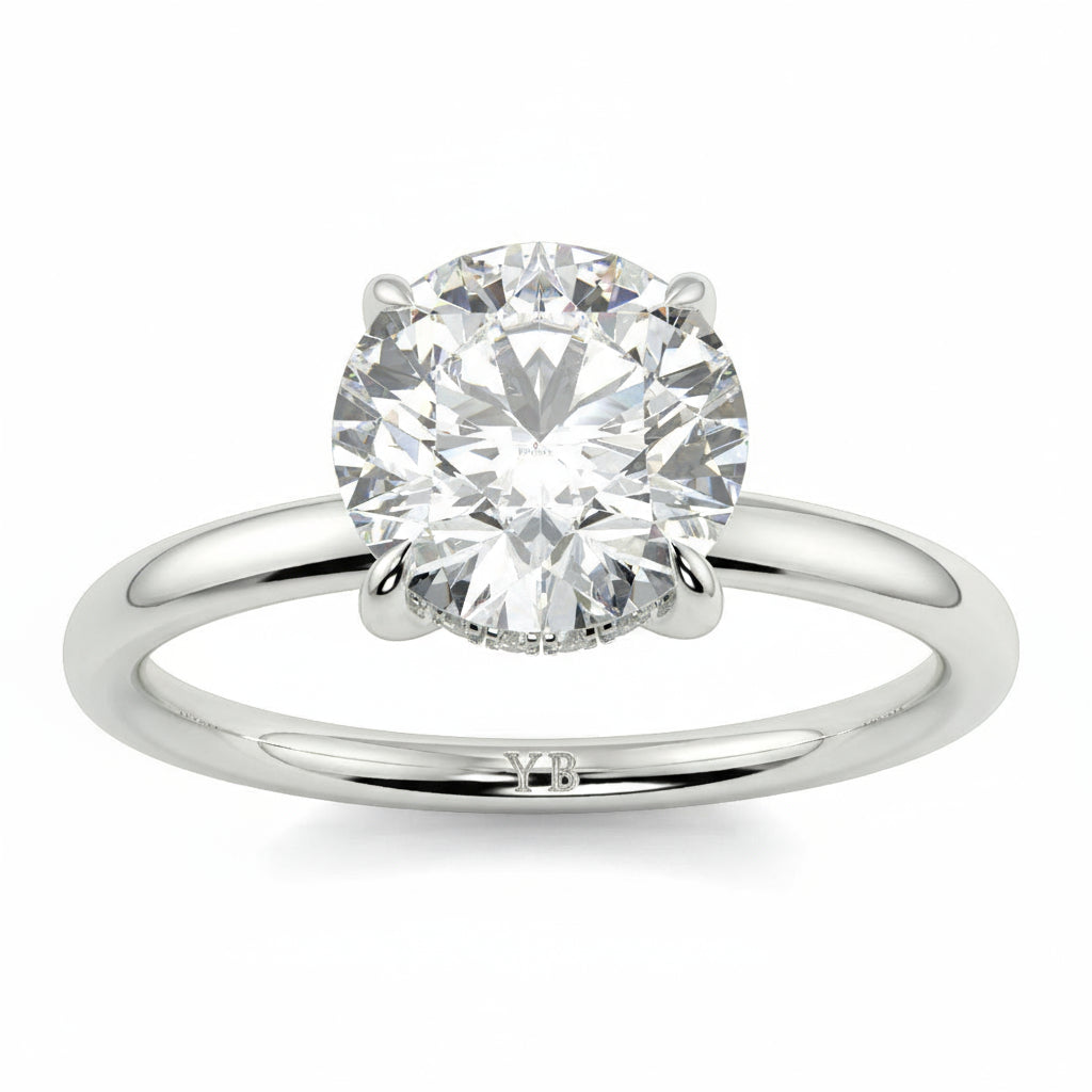 Diamond ring with 'Floyd' engraving on a white background _yb_jewellers_solitaire_engagement_ring_best_selling_design_cushion_shape_diamond_4_claw_with_a_slim_band