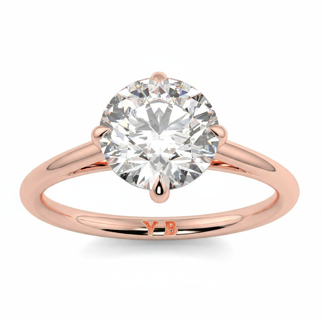 Rose gold ring with a large diamond and 'LUVORE' branding on a white  background yb jewellers 4 claw compass claw best selling engagement ring thin band 4 claw ring