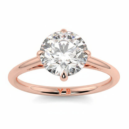 Rose gold ring with a large diamond and 'LUVORE' branding on a white  background yb jewellers 4 claw compass claw best selling engagement ring thin band 4 claw ring
