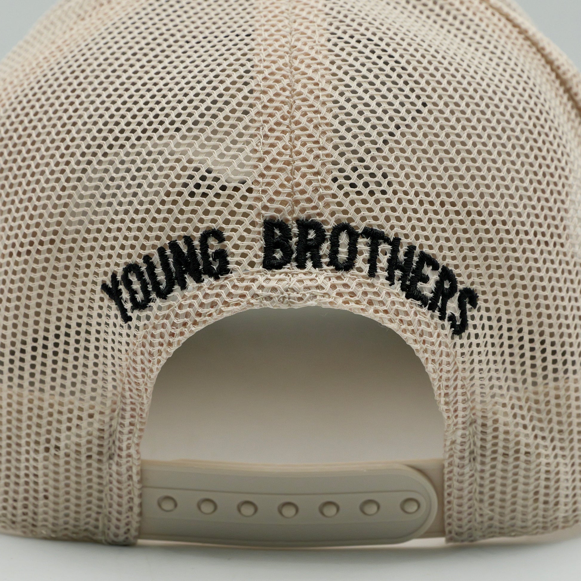 Beige mesh cap with 'YOUNG BROTHERS' text on a light gray background