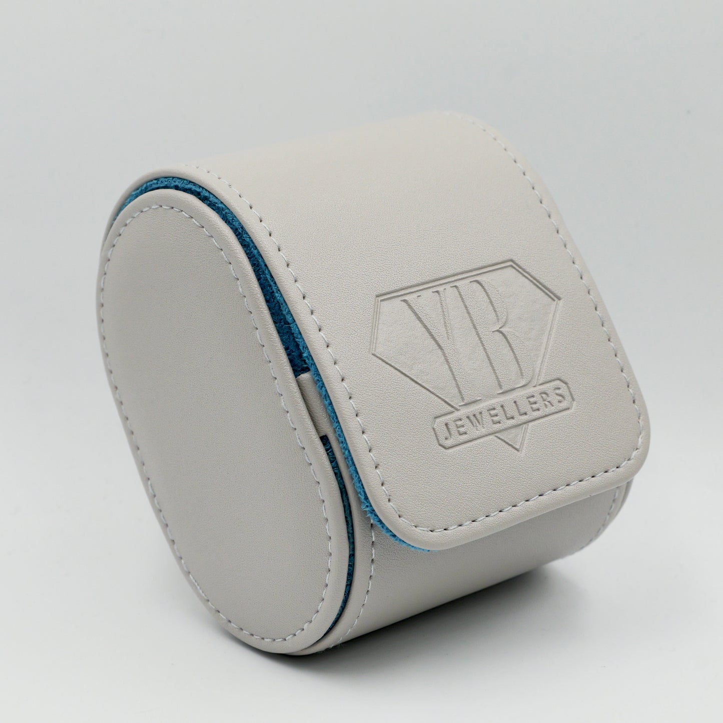 Gray jewelry box with Yb Jewellers logo on a light gray background