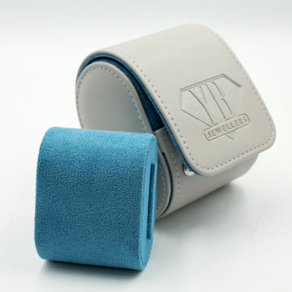 White jewelry box with blue interior and visible brand logo on a white background