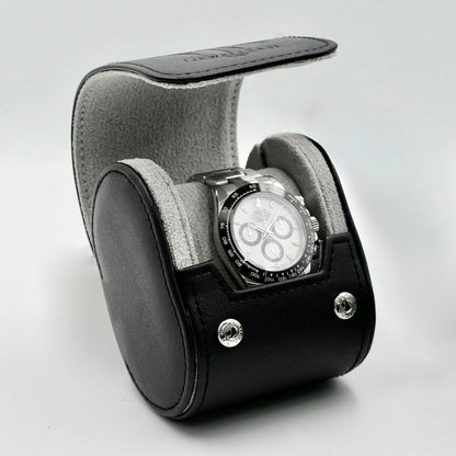 Watch in a black and gray display case on a light gray background