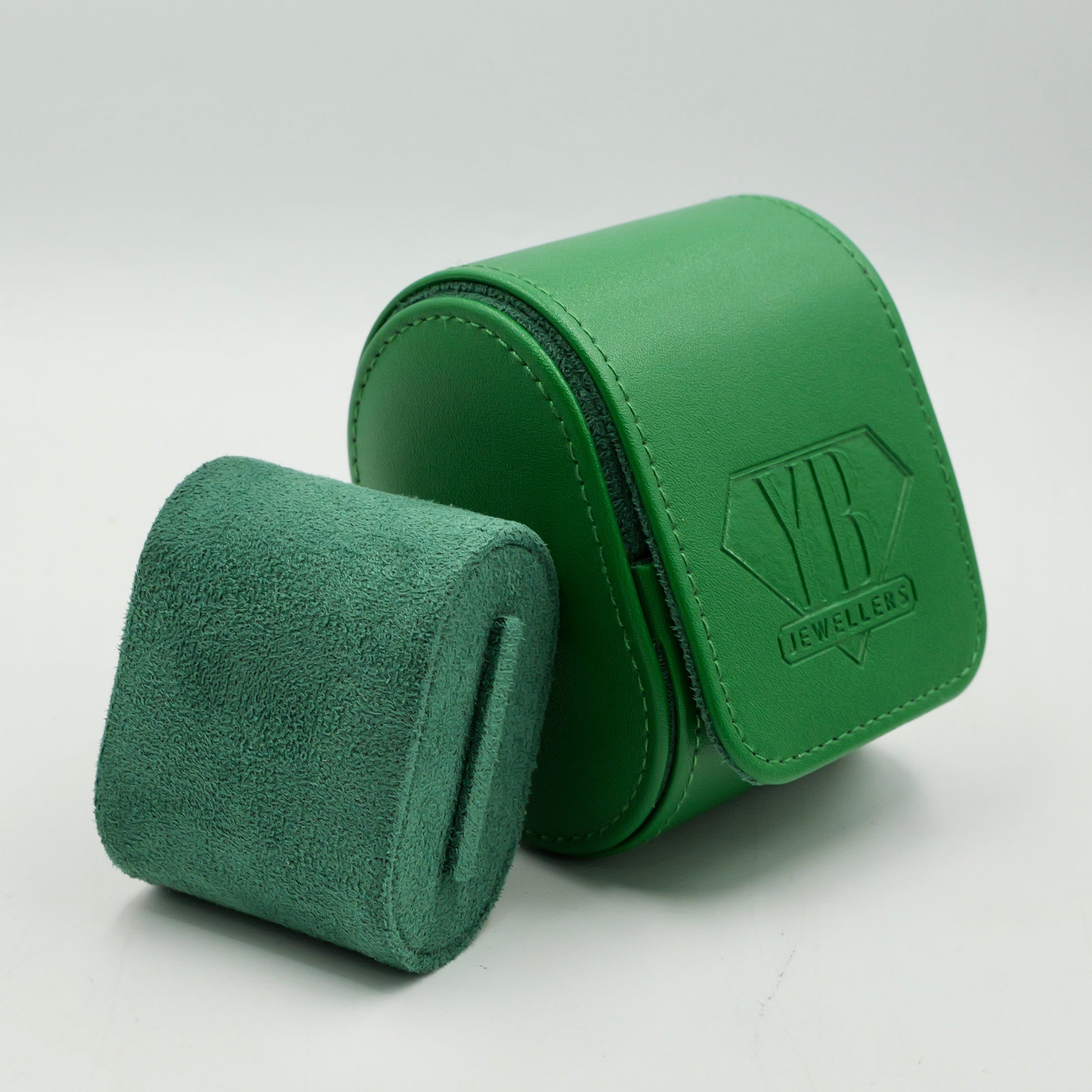 Green jewelry box with a textured surface on a white background