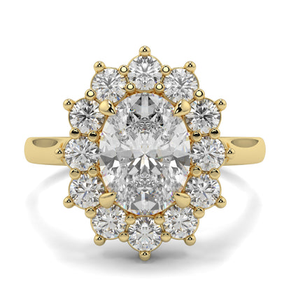 Gold ring with a central diamond and smaller diamonds around on a white background, Yb jewellers engagement ring with a cluster halo and oval diamond trending design 