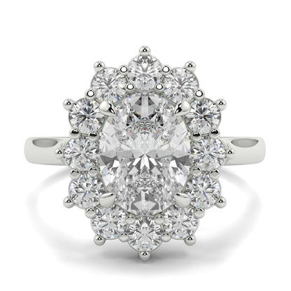 Diamond ring with a central gemstone and smaller diamonds on a white background Yb jewellers engagement ring with a cluster halo and oval diamond trending design 