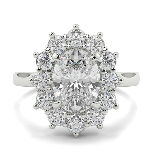 Diamond ring with a central gemstone and smaller diamonds on a white background Yb jewellers engagement ring with a cluster halo and oval diamond trending design 