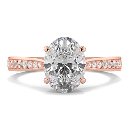 Rose gold ring with a large diamond and smaller diamonds on the band against a white background Yb jewellers engagement ring straight band