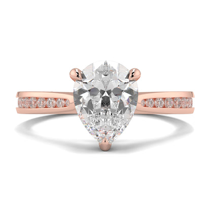 Rose gold ring with a pear-shaped diamond and smaller diamonds on the band against a white background Yb jewellers engagement ring straight band