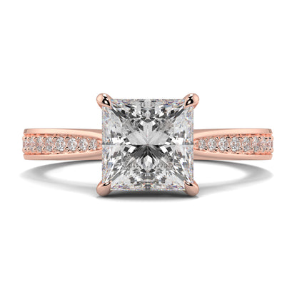 Rose gold ring with a large diamond and smaller diamonds on the band against a white background Yb jewellers engagement ring straight band princess cut diamond