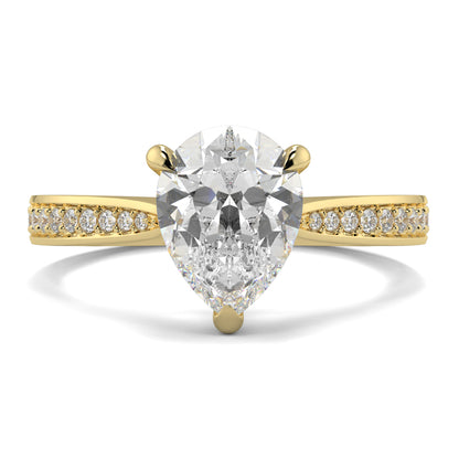 Gold ring with a pear-shaped diamond and smaller diamonds on the band against a white background Yb jewellers engagement ring straight band