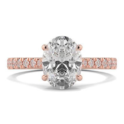 Rose gold ring with a large diamond and smaller diamonds on the band against a white background Yb jewellers engagement ring straight band 
