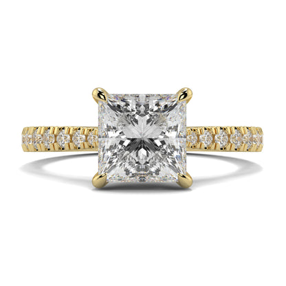 Gold ring with a large diamond and smaller diamonds on the band against a white background Yb jewellers engagement ring straight band princess diamond