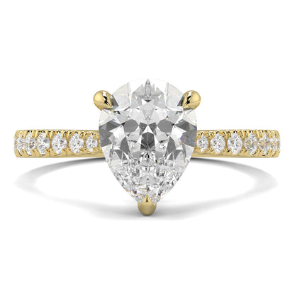 Gold ring with a pear-shaped diamond and smaller diamonds on the band against a white background Yb jewellers engagement ring straight band pear diamond 