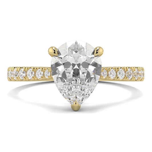 Gold ring with a pear-shaped diamond and smaller diamonds on the band against a white background Yb jewellers engagement ring straight band pear diamond 