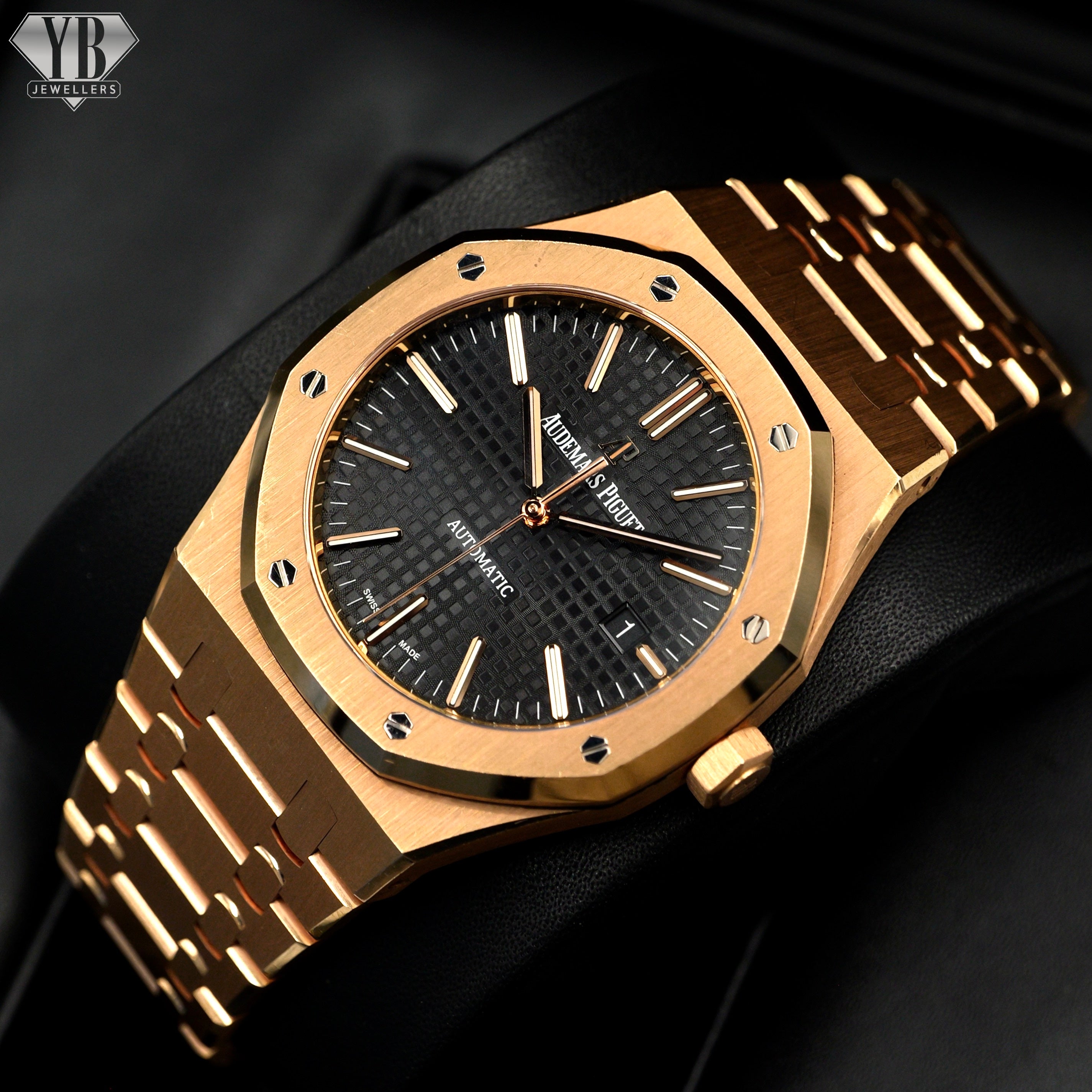 Gold watch with black face on a dark background