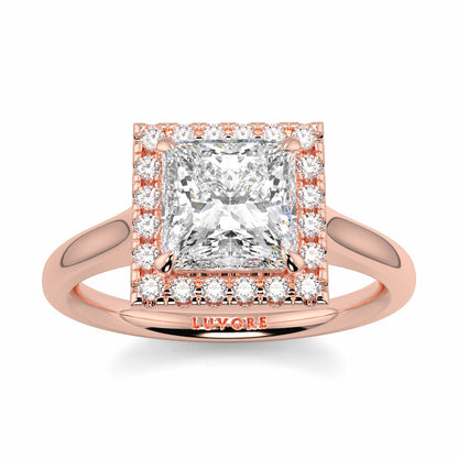 Rose gold ring with a large diamond and smaller diamonds on a white background Yb jewellers princess cut diamond halo plain shoulders 