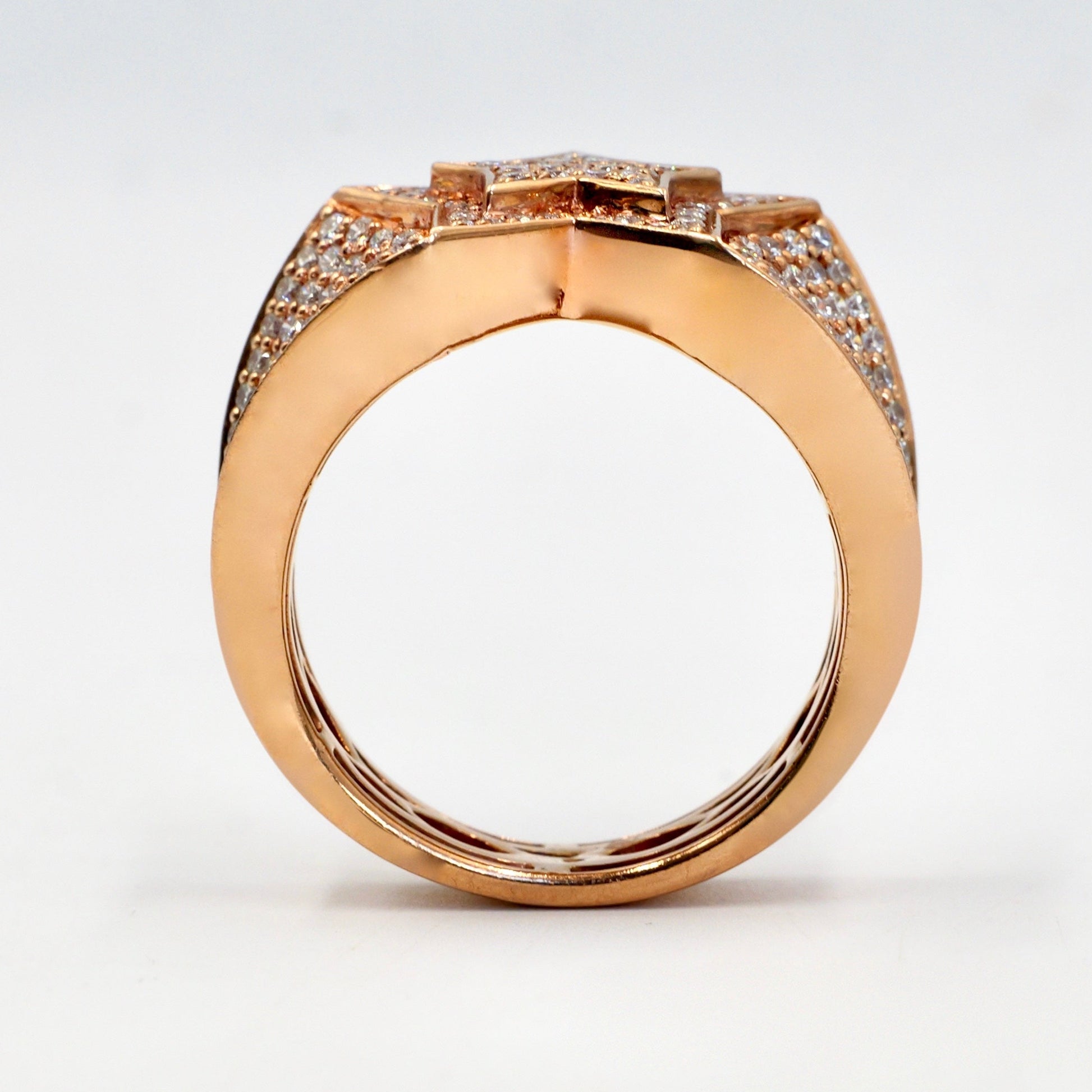 Rose gold ring with diamond accents on a white background