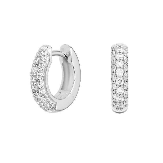 Silver hoop earrings with embedded stones on a green background pair of huggiee earrings in 18k white gold platinum with micro diamond setting by yb jewellers 