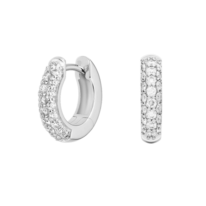 Silver hoop earrings with embedded stones on a green background pair of huggiee earrings in 18k white gold platinum with micro diamond setting by yb jewellers 