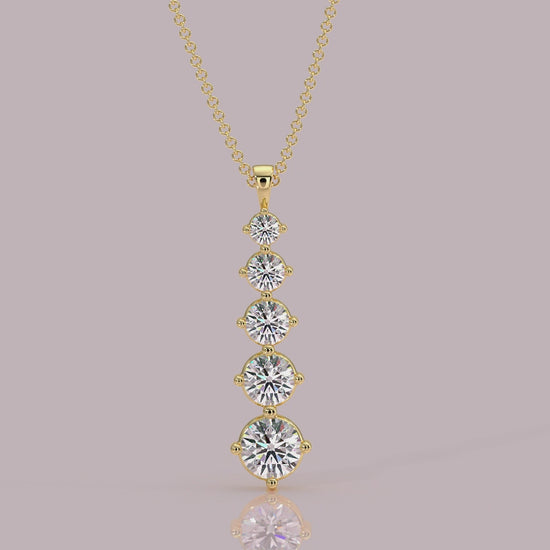 Model wearing Aurora five‑stone diamond necklace, graduated downwards, 18k yellow gold