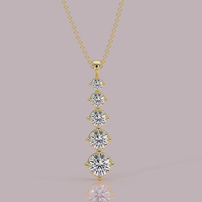 Model wearing Aurora five‑stone diamond necklace, graduated downwards, 18k yellow gold