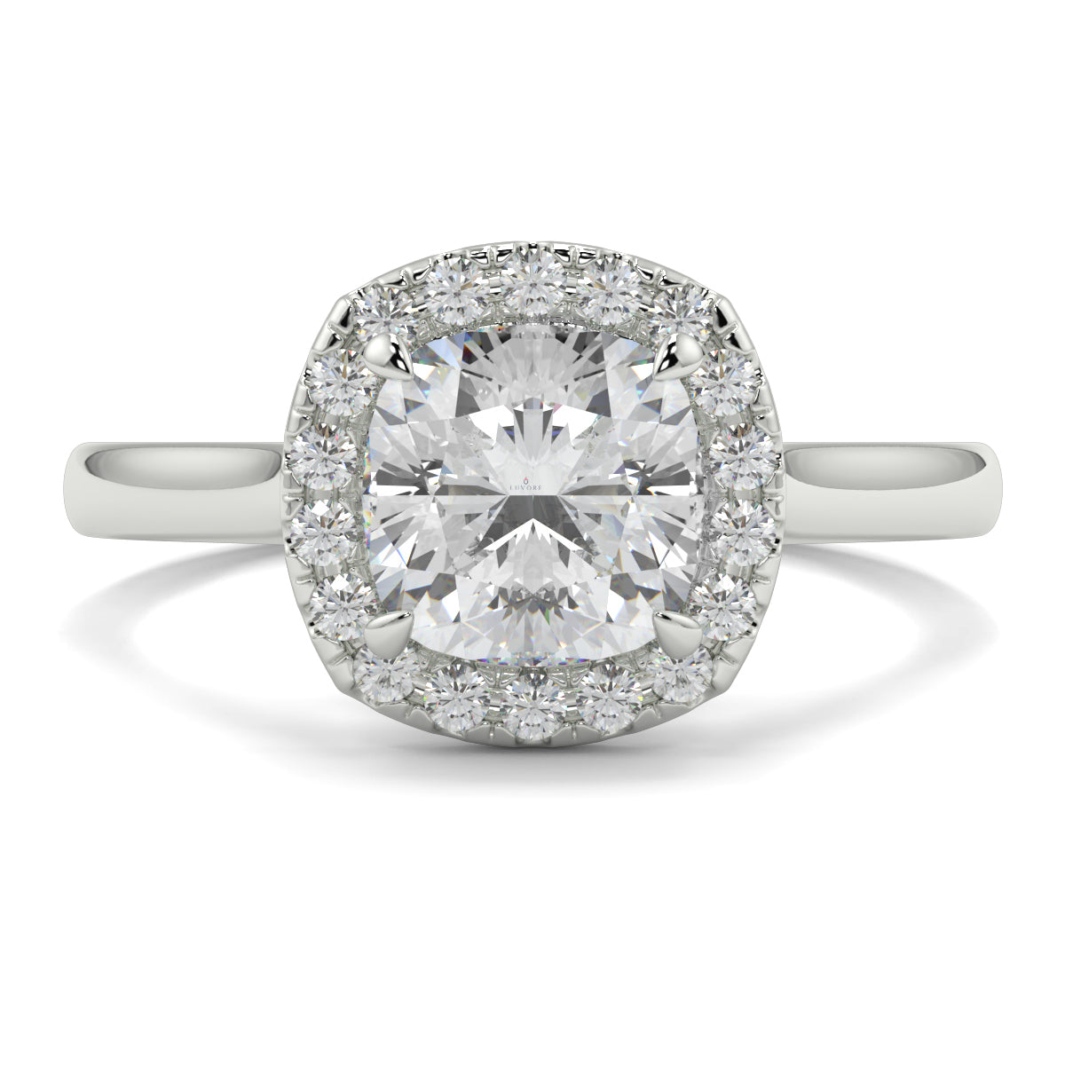 Diamond ring with a cushion-cut center stone and smaller diamonds around on a white background single halo with plain shoulder diamond engagement ring yb jewellers best seller trending ring 